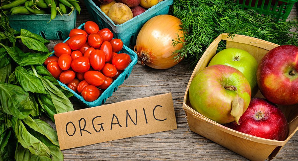 {"en-us":"Organic fruits and vegetables on wooden table"}